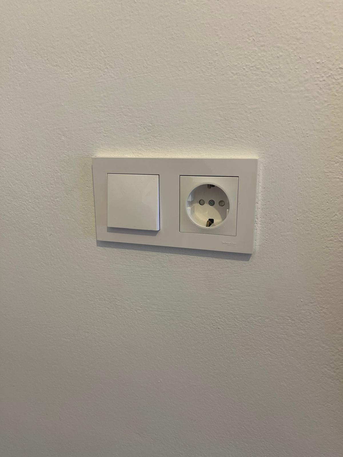 Enchufe e interruptor instalados en pared